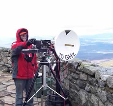 Paul aims the 10GZ dish during the '05 expedition, covered in ice.